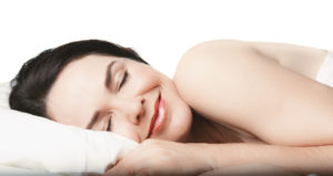 Woman with night guard sleeps peacefully
